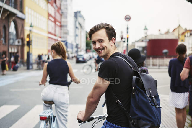 Young man riding bicycle in Copenhagen, Denmark, selective focus — Stock Photo