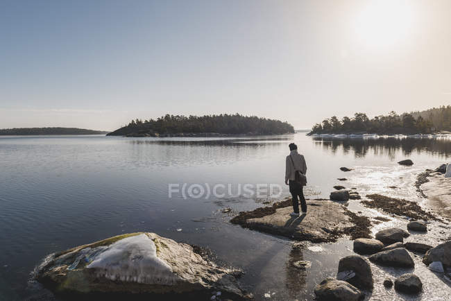 Man standing by lake, selective focus — Stock Photo