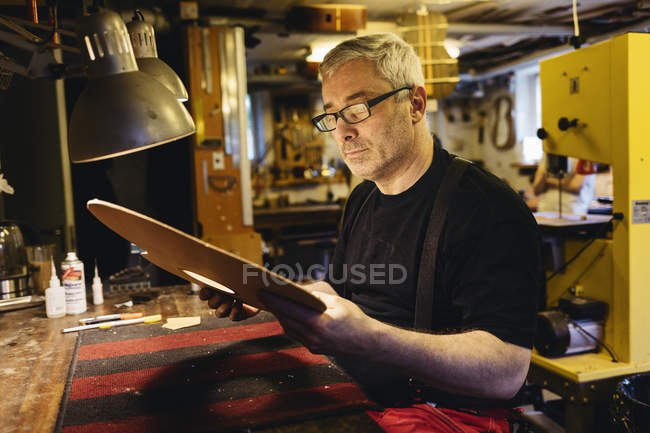 Craftsman working in guitar making workshop, selective focus — Stock Photo
