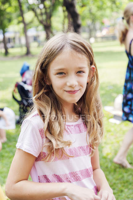 Portrait of girl at birthday party in park, focus on foreground — Stock Photo