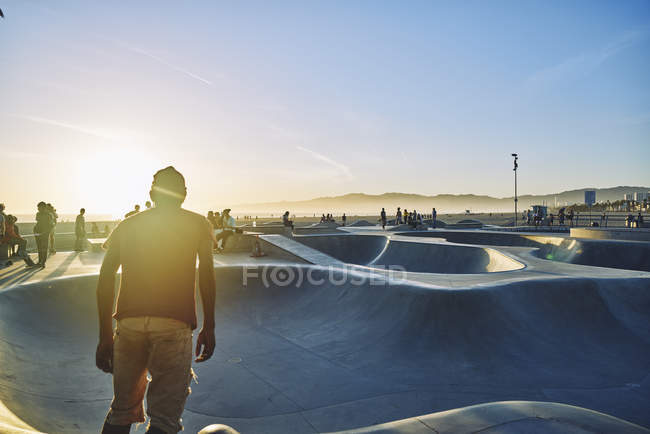 Вид сзади на скейтбординг для подростков на пляже Венеция, США — стоковое фото