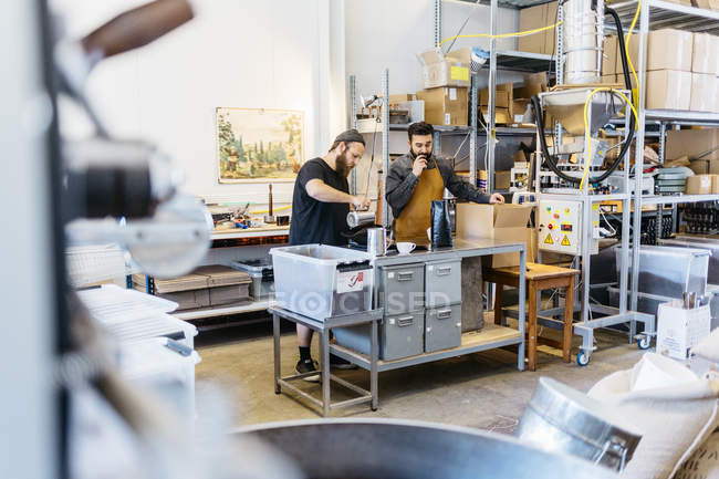 Two men making coffee at commercial kitchen, selective focus — Stock Photo