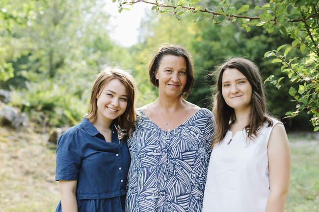 Portrait of mother and daughters in forest — Stock Photo
