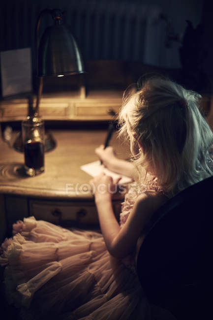 Girl writing at letter at desk, selective focus — Stock Photo