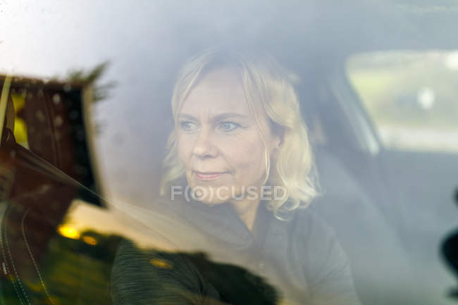 Mature woman in car, selective focus — Stock Photo