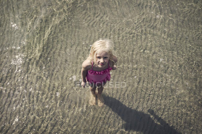 Girl standing in sea seen from above — Stock Photo