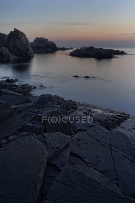Rochers par la mer au coucher du soleil à Kullen, Suède — Photo de stock