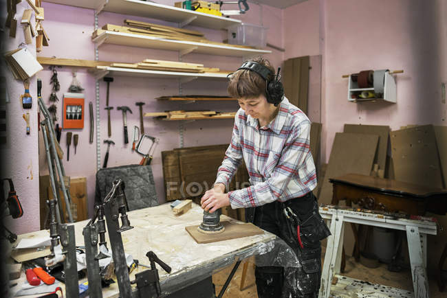 Carpenter sanding wood, selective focus — Stock Photo