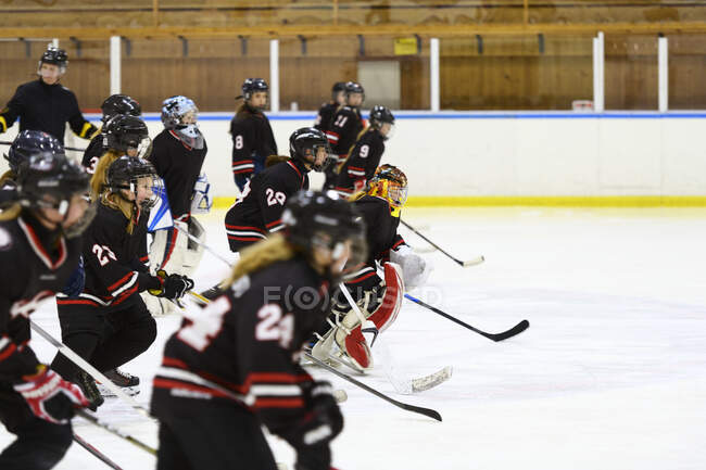 Girls skating during ice hockey training — Stock Photo