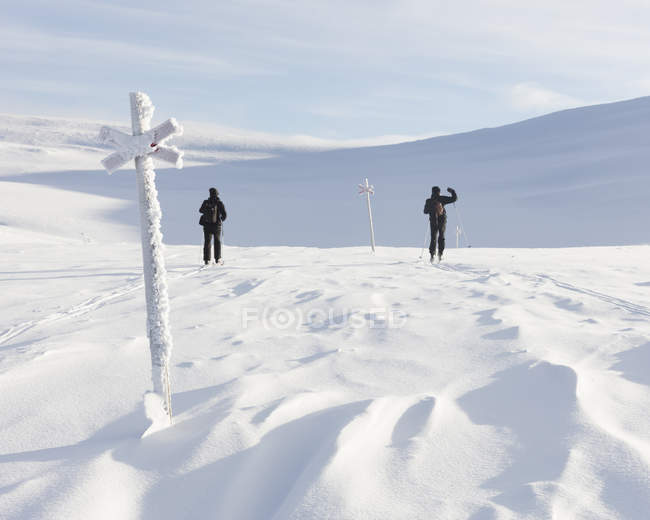 Men skiing by markers, selective focus — Stock Photo