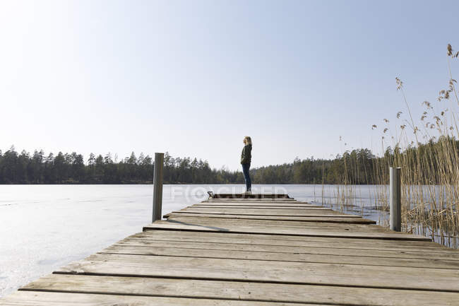 Woman standing on pier, selective focus — Stock Photo