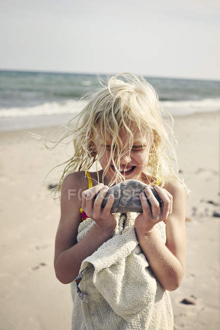 Girl carrying rock on beach, selective focus — Stock Photo
