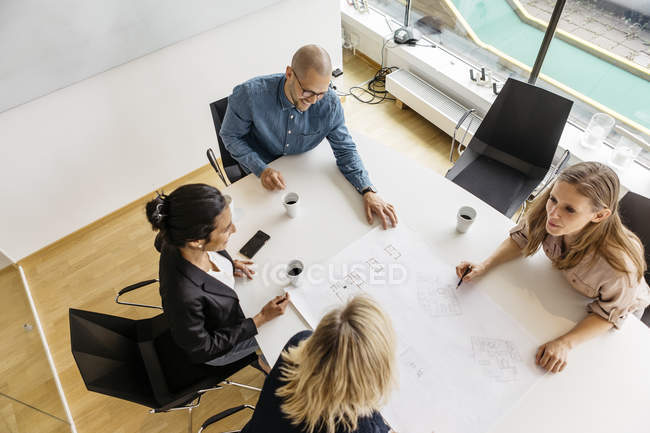 Businesspeople looking at plans during meeting — Stock Photo