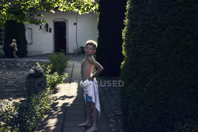 Boy wearing towel in back yard — Stock Photo