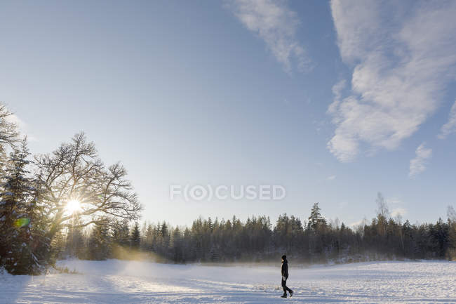 Mature woman walking through snow in Ostergotland, Sweden — Stock Photo