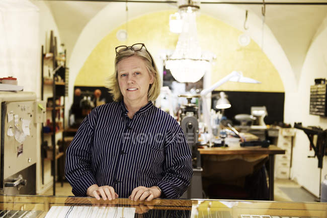 Portrait of goldsmith at counter of store — Stock Photo