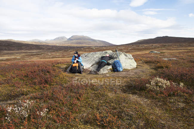 Woman resting on boulder, selective focus — Stock Photo