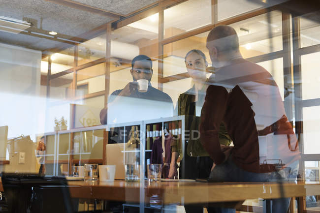 View through window of businesspeople in meeting — Stock Photo