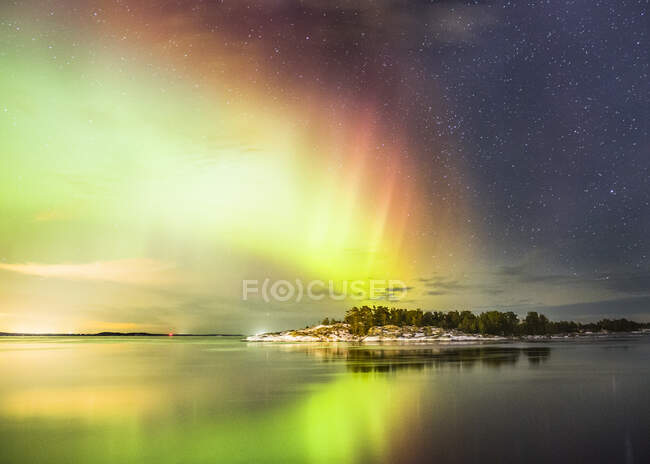 Northern lights reflected in water, amazing natural view — Stock Photo