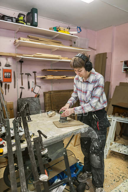 Carpenter sanding wood, selective focus — Stock Photo