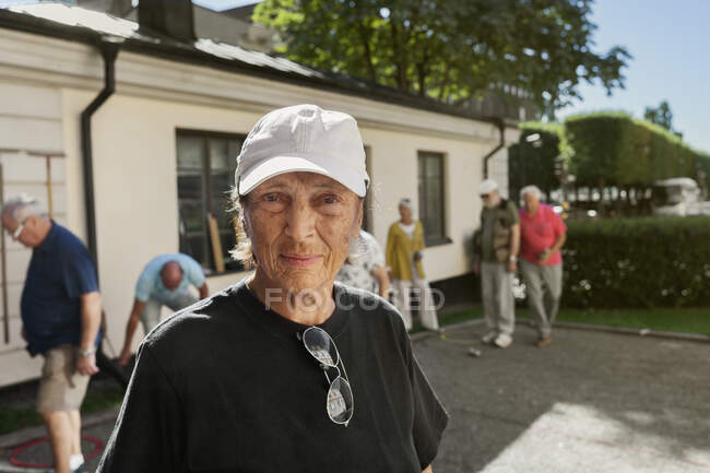 Portrait of senior woman looking at camera outdoors — Stock Photo