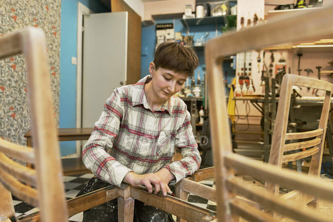 Carpenter sanding chair, selective focus — Stock Photo