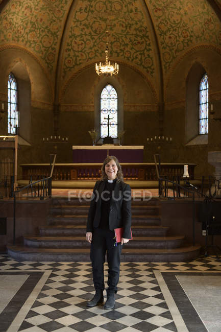 Portrait of priest in church, selective focus — Stock Photo