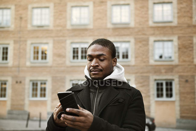 Hombre adulto medio usando el teléfono inteligente - foto de stock