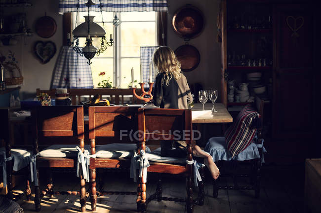 Girl at dining table, selective focus — Stock Photo