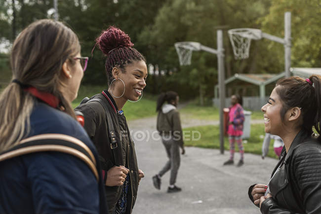 Teenage girls smiling in park, selective focus — Stock Photo