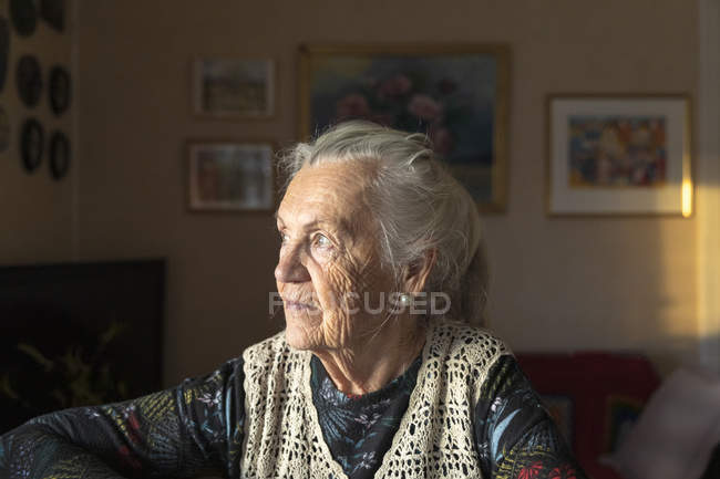Portrait of senior woman, focus on foreground — Stock Photo