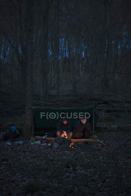 Hommes campant dans la forêt la nuit, focus sélectif — Photo de stock