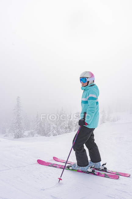 Девочка-подросток катается на лыжах зимой, вид в полный рост — стоковое фото