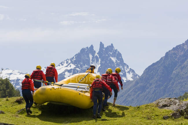 Rear view of people preparing for rafting, Chile                                   Model Releases — Stock Photo