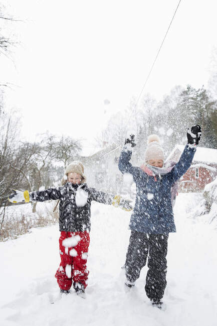 Сестри грають у снігу — стокове фото