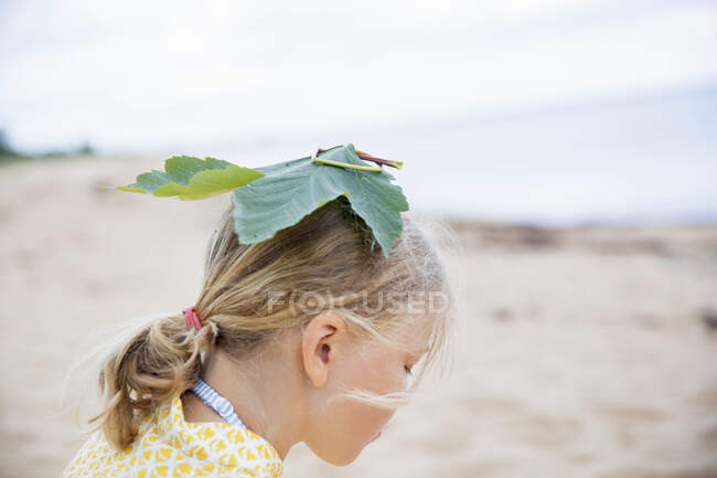 Girl with leaf on head — Stock Photo