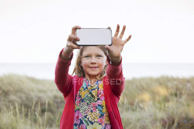 Дівчинка сідає на піщані дюни. — стокове фото