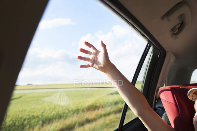 Girl's raised arm in car — Fotografia de Stock