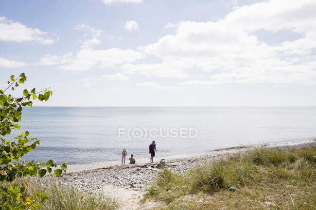 Family of three on beach — Stock Photo