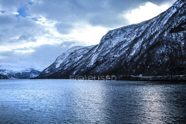Neige sur la montagne par la mer — Photo de stock