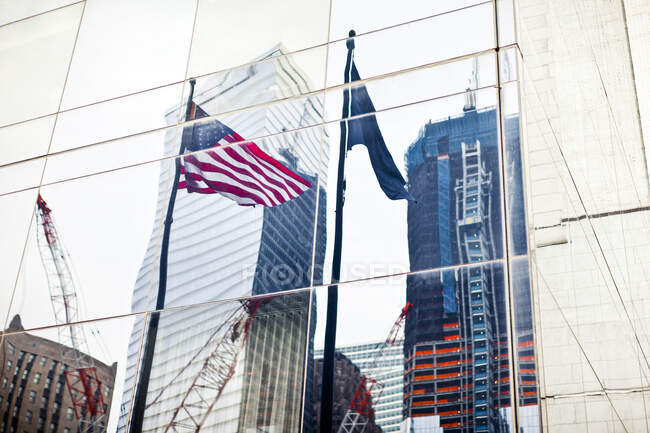 Reflection of American flag in window of building — Stock Photo