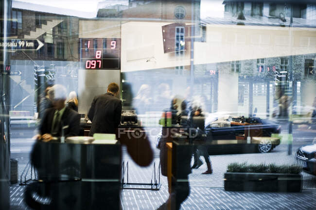 Отражение людей в окнах и на улицах города — стоковое фото