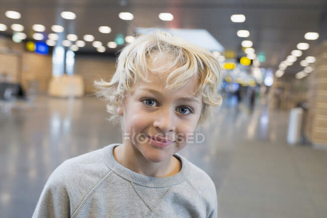 Happy young boy at airport — Stock Photo