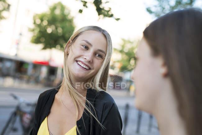 Усміхнена молода жінка і її сестра — стокове фото