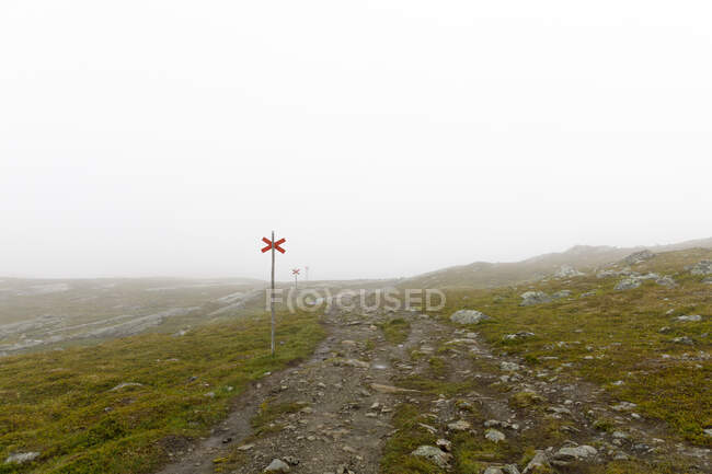 Red cross sign on hiking trail in Jamtland, Sweden - foto de stock