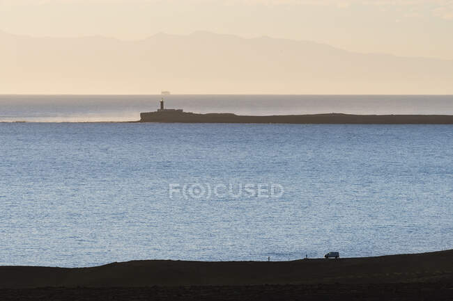 Lighthouse and coastline at sunset - foto de stock
