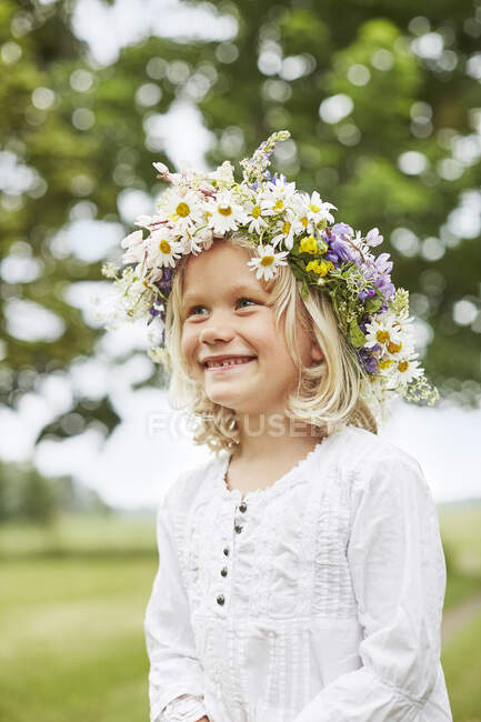 Menina sorridente em flor coroa — Fotografia de Stock