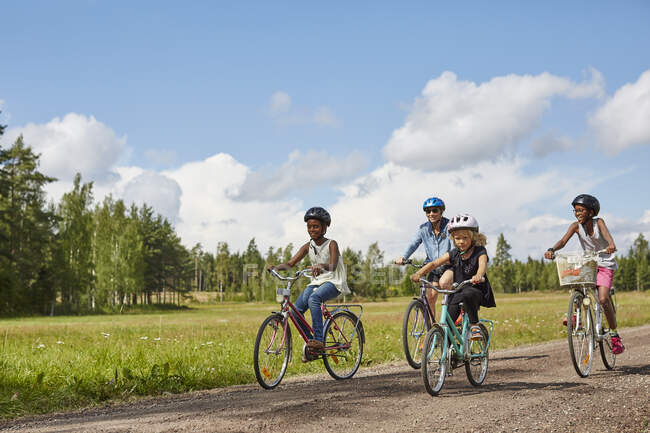 Family cycling on rural road — Stock Photo