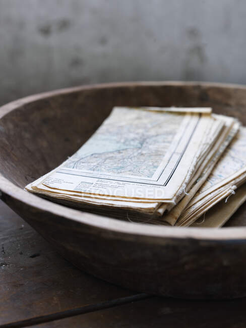 Maps in wooden bowl — Stock Photo