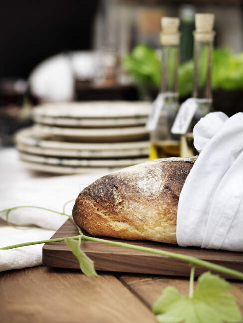 Fresh bread on wooden cutting board — Stock Photo